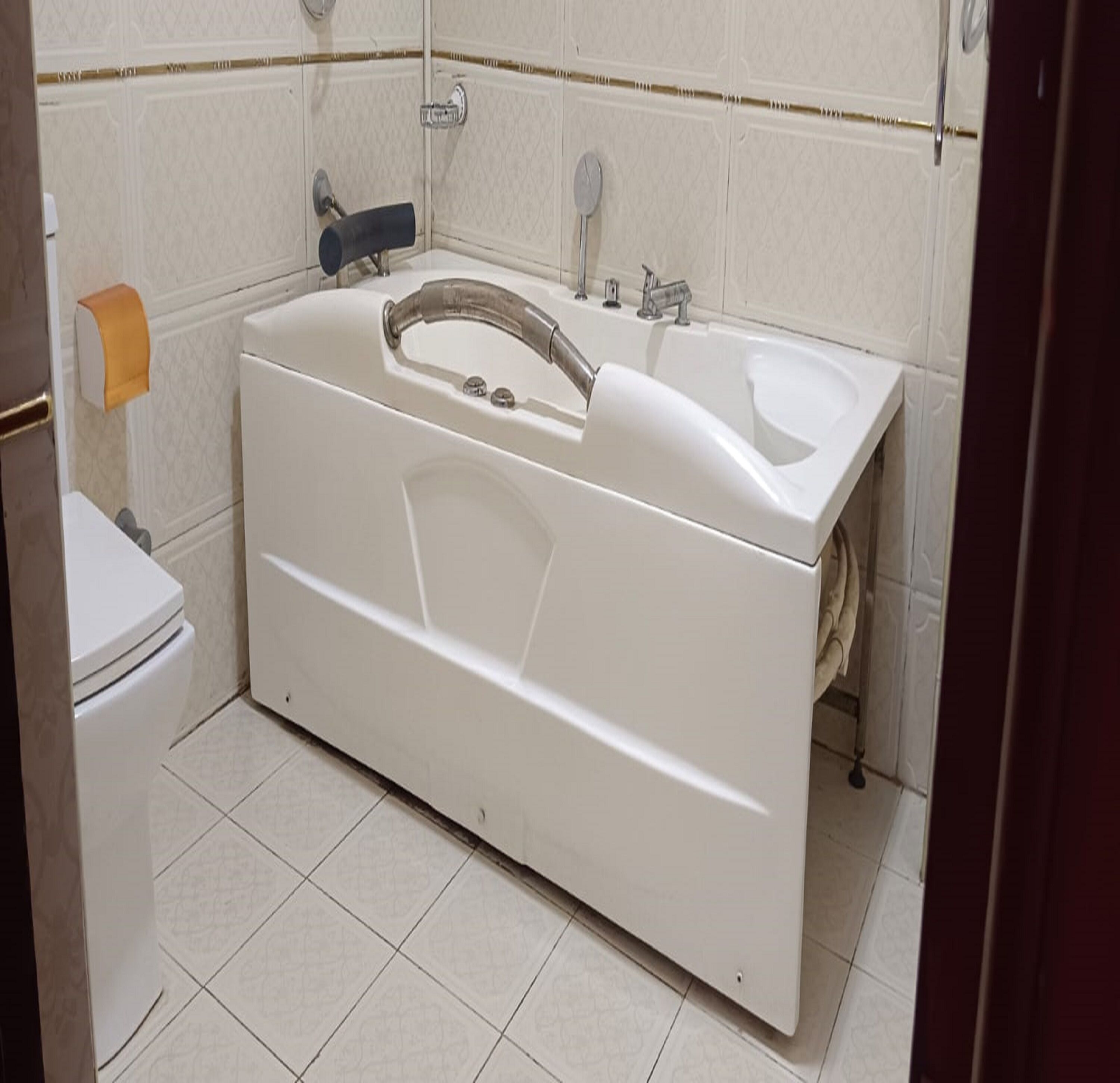 Une salle de bain avec une baignoire, des toilettes et un porte-serviettes.