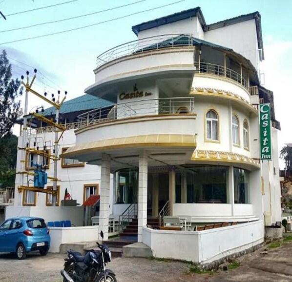 A two-story building with a sign reading "Casita Inn". It features a balcony on the upper floor and a covered entrance area. - TNV Casita Inn (Yercaud)