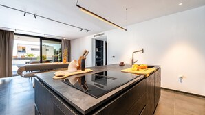 A modern kitchen with a central island, a built-in oven, and a sleek faucet.