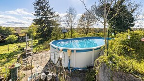 A swimming pool in a backyard with a ladder, surrounded by trees and a fence. - Bed and Breakfast 'Chambre Pissaro' with Shared Pool, Private Terrace and Wi-Fi (Sanxay)