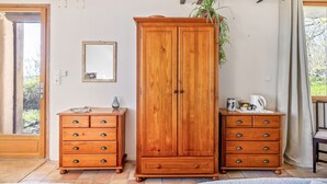 A room with wooden furniture, a mirror, and a plant. - Bed and Breakfast 'Chambre Pissaro' with Shared Pool, Private Terrace and Wi-Fi (Sanxay)