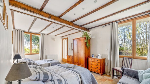 A bedroom with a bed, a dresser, a chair, and a window with curtains. - Bed and Breakfast 'Chambre Pissaro' with Shared Pool, Private Terrace and Wi-Fi (Sanxay)