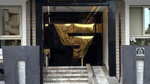 A grand entrance with a marble staircase leading up to a black door with a golden decorative element. - Deluxe Room at Stay Inn 51 Hotel (2 Adults + 1 Child) (Banī Ghālib)
