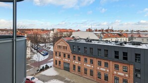 A view of a building with a brick facade and a modern structure with a flat roof. - Modern Studio in Wrzeszcz | Balcony | Close to the Station (Gdańsk)
