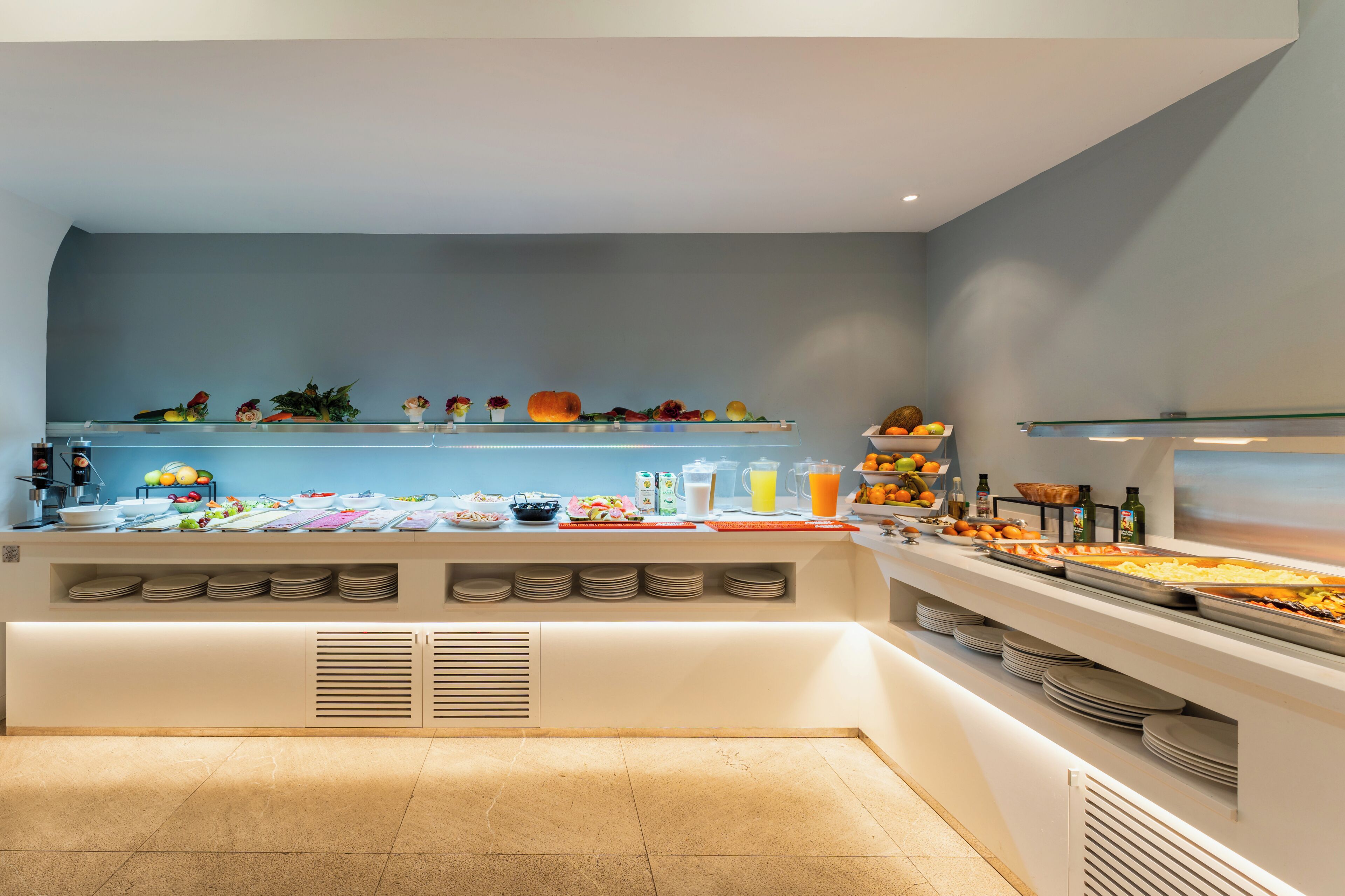 A buffet setup with various food items and beverages.