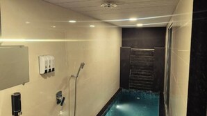 A modern bathroom with a marble sink, a built-in jacuzzi, and a large mirror. - Rumourss Sky Villa (Lonavala)