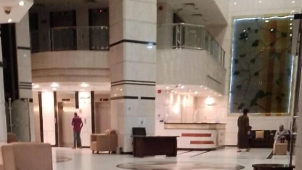 A spacious lobby with a reception desk, seating area, and a large decorative wall. - Jawaher Al Hashmiya- 6 (Makkah)