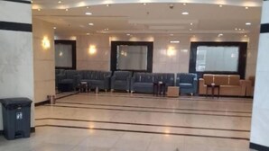 A spacious lobby with a seating area featuring sofas and armchairs, a marble floor, and a large window providing natural light. - Jawaher Al Hashmiya- 6 (Makkah)