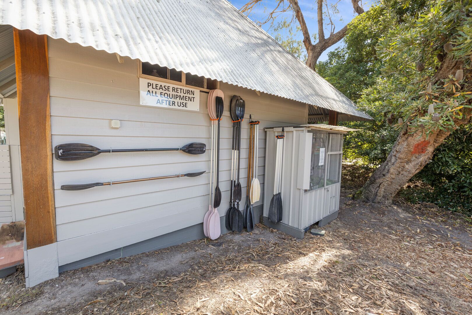 A small building with a sign requesting the return of all equipment after use.