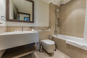 A modern bathroom with a sink, toilet, and bathtub. - Waterfront Community, Beachfront Living Near Dubai Marina and Top Dining Hotspots (Dubai)