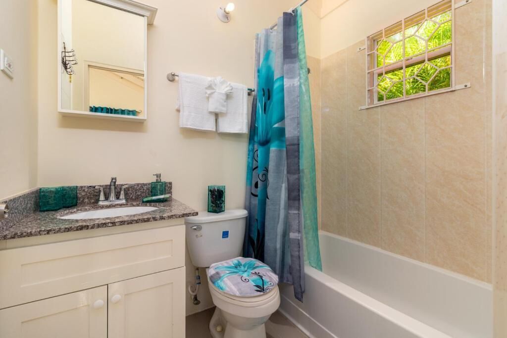A bathroom with a toilet, sink, and bathtub.