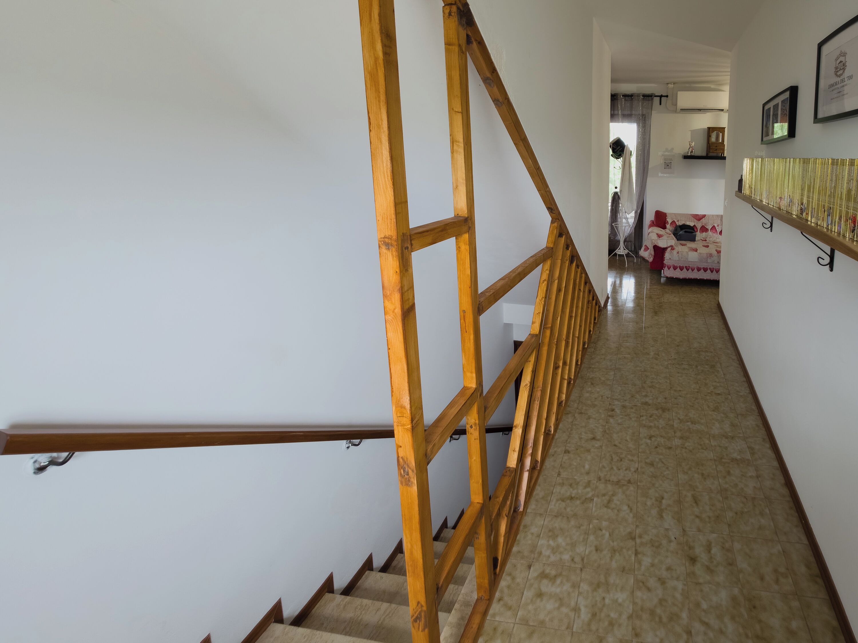 A staircase with wooden railings leading to a landing.