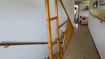 A staircase with wooden railings leading to a landing.
