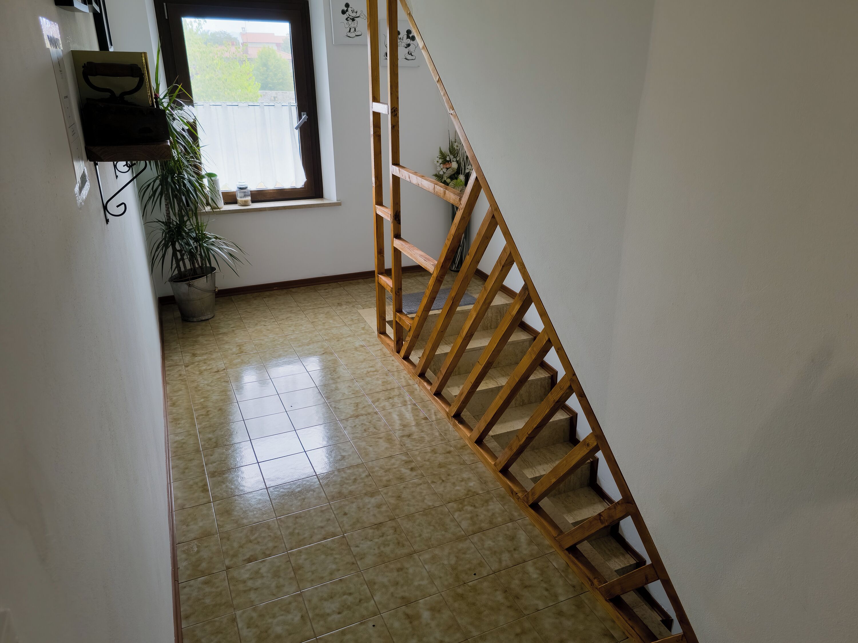 A staircase with wooden railings leading to a landing.