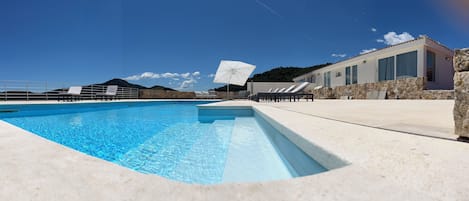 Outdoor pool, pool umbrellas, sun loungers