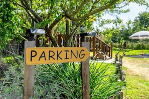 A yellow parking sign with the word 'PARKING' in black letters.