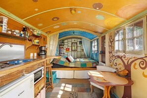 A compact, well-equipped kitchen with a refrigerator, microwave, and sink.