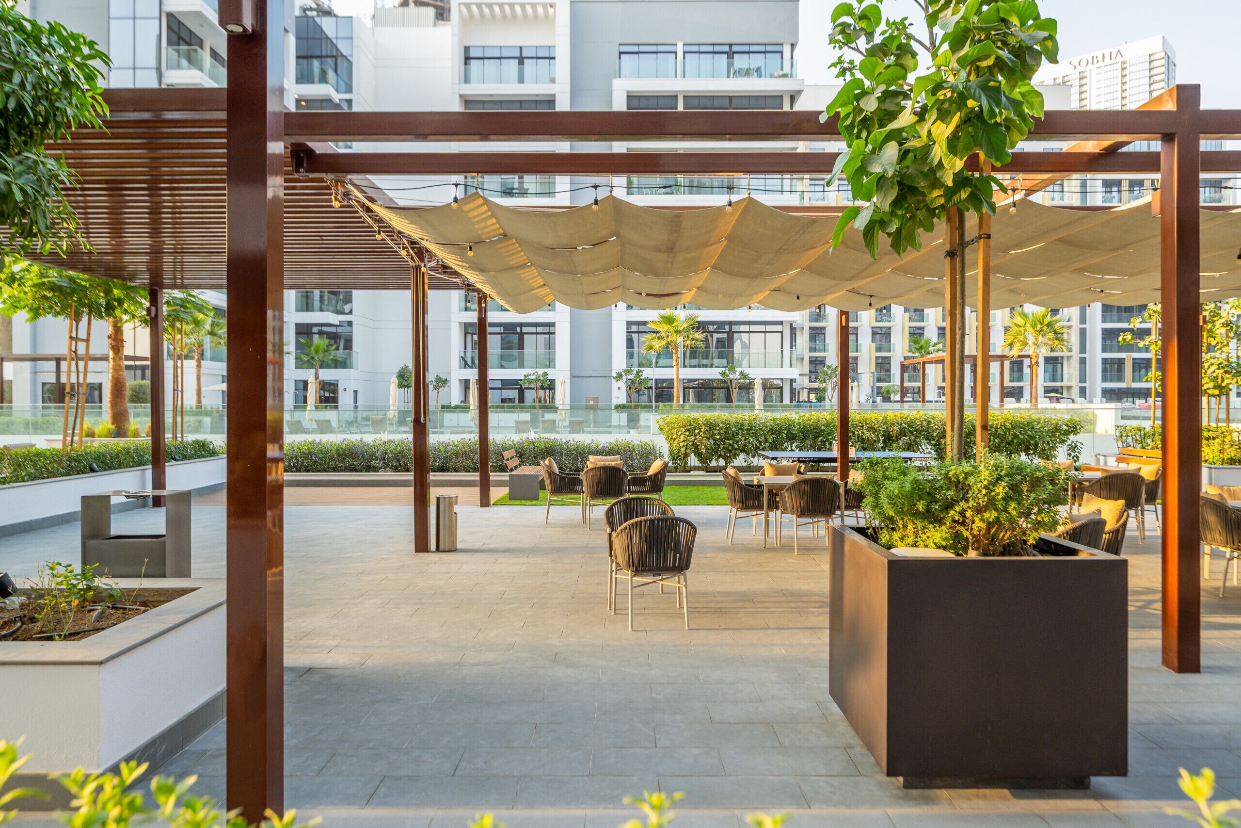 An outdoor patio area with seating arrangements and planters.