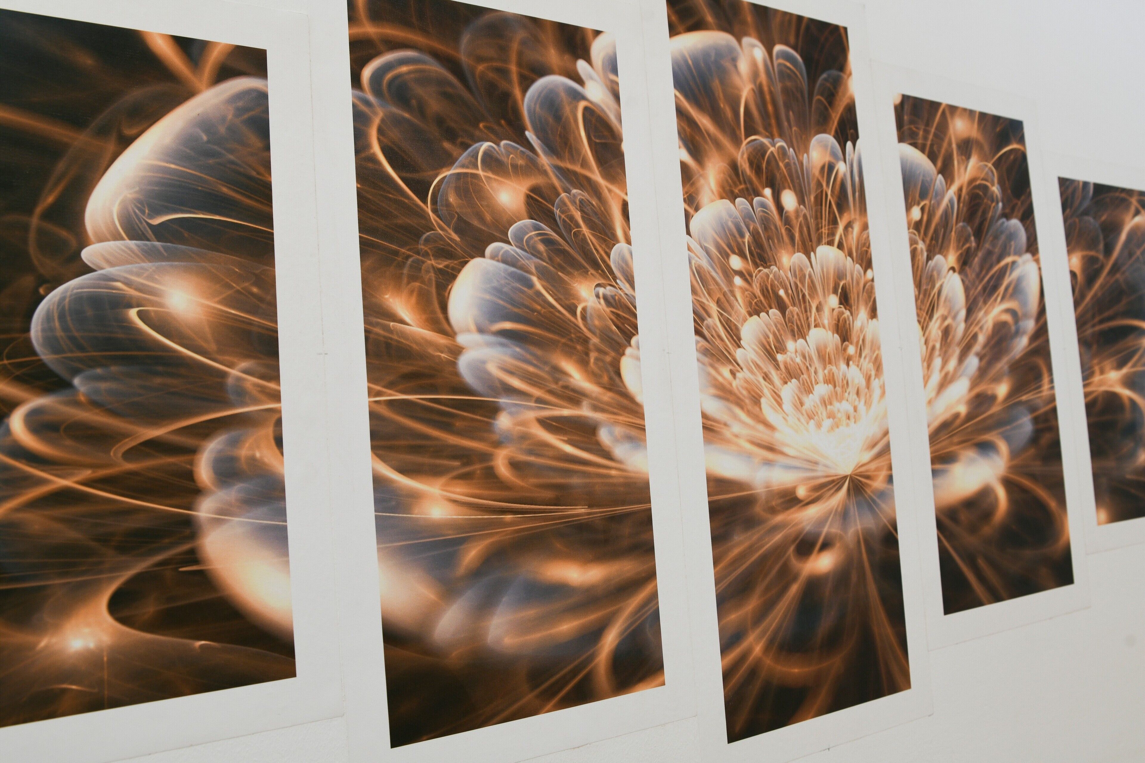 A wall with multiple framed artworks.