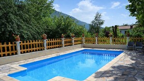 A rectangular swimming pool with a stone border, surrounded by a wooden fence and potted plants. - Guest Room 2 with Shared Pool, Communal Garden and Wi-Fi (Betton-Bettonet)