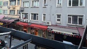 A multi-story building with a gray facade, multiple windows, and balconies. - Besiktas1 (İstanbul)