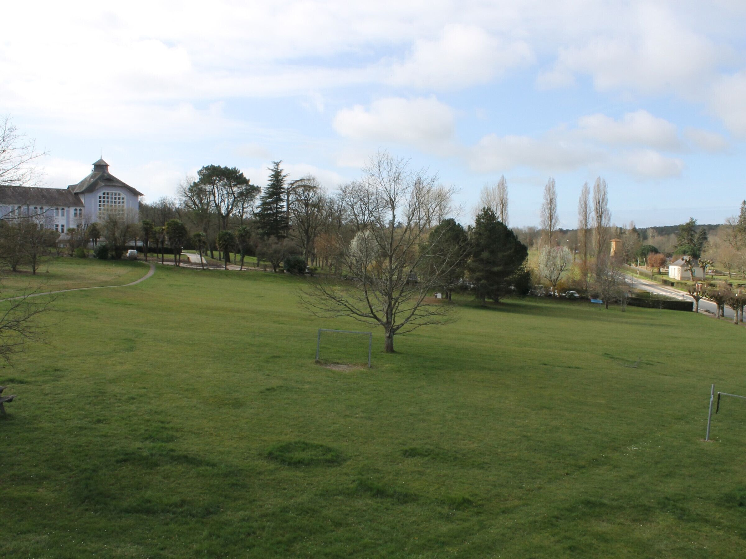 A grassy field with a building in the background.