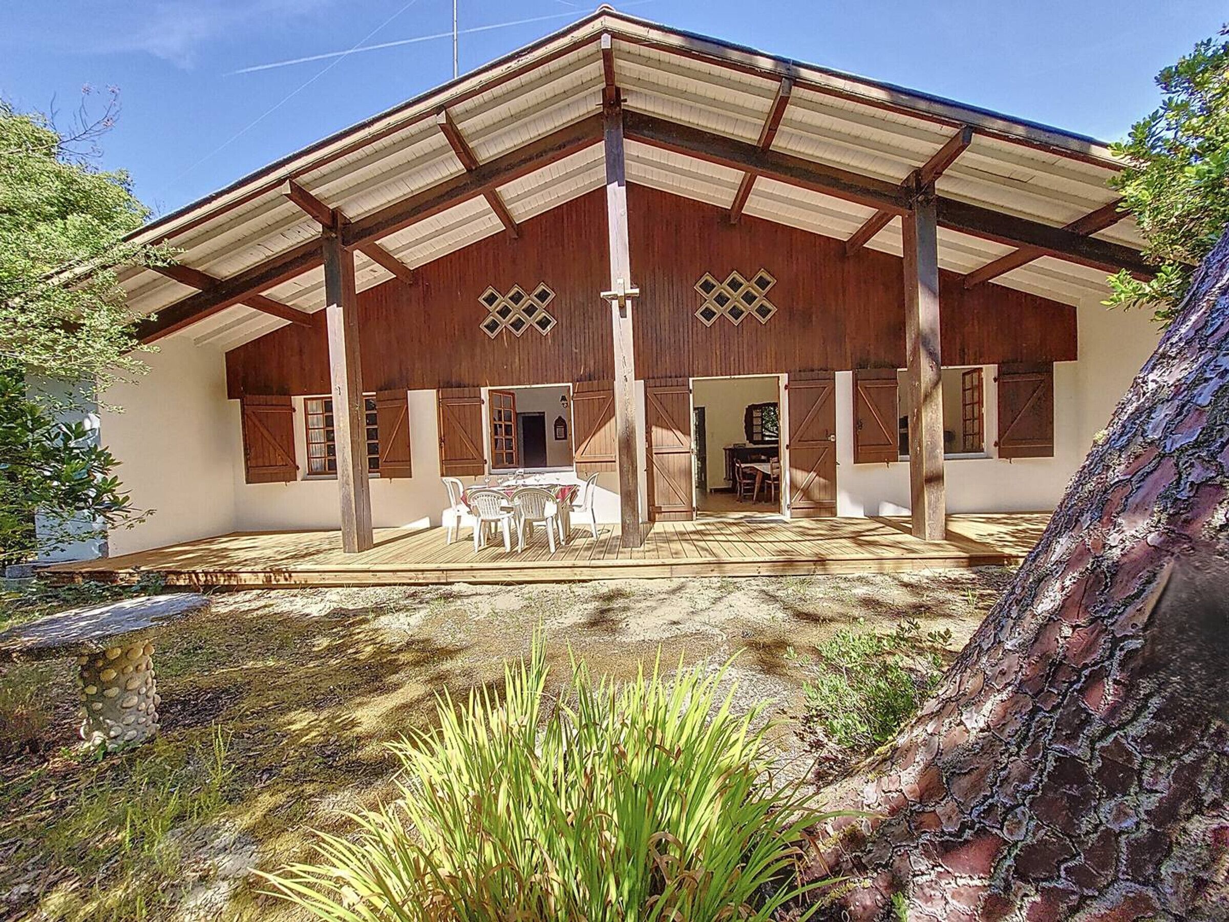 A rustic barn-style building with a covered patio, a dining area, and a visible interior space.