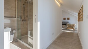 Un bagno moderno con box doccia in vetro, un water e un lavandino.