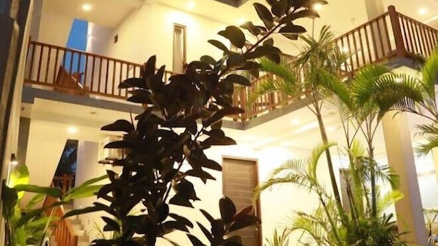 A multi-story building with balconies and a well-lit exterior. - PRIIMA (Ahangama)