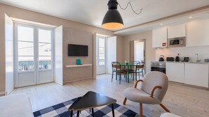Un appartamento moderno con zona pranzo, cucina e un balcone vista panoramica.