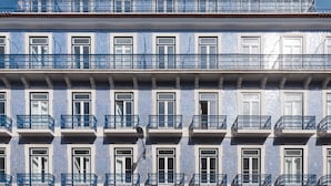 A building with multiple balconies and windows, featuring blue and white patterned tiles. - Ando Living - Abrantes 50 House - 504 (Lisbon)