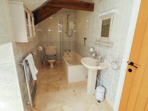 A bathroom with a toilet, bathtub, sink, and a shower. - 3 Christon Bank Mews (Alnwick)