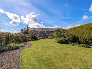 A large stone house with a well-maintained lawn and garden. - 3 Christon Bank Mews (Alnwick)