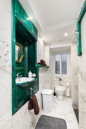 A bathroom with a green vanity, white sink, and a toilet. - Traditional Townhouse - Rooftop Seaviews (Cospicua)