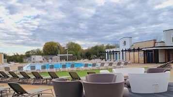 A poolside area with lounge chairs and a swimming pool.