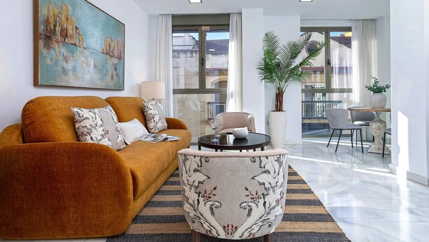 A modern living room with a sofa, armchair, and a dining table with chairs. - Genteel Home Uceda III (Cordoba)