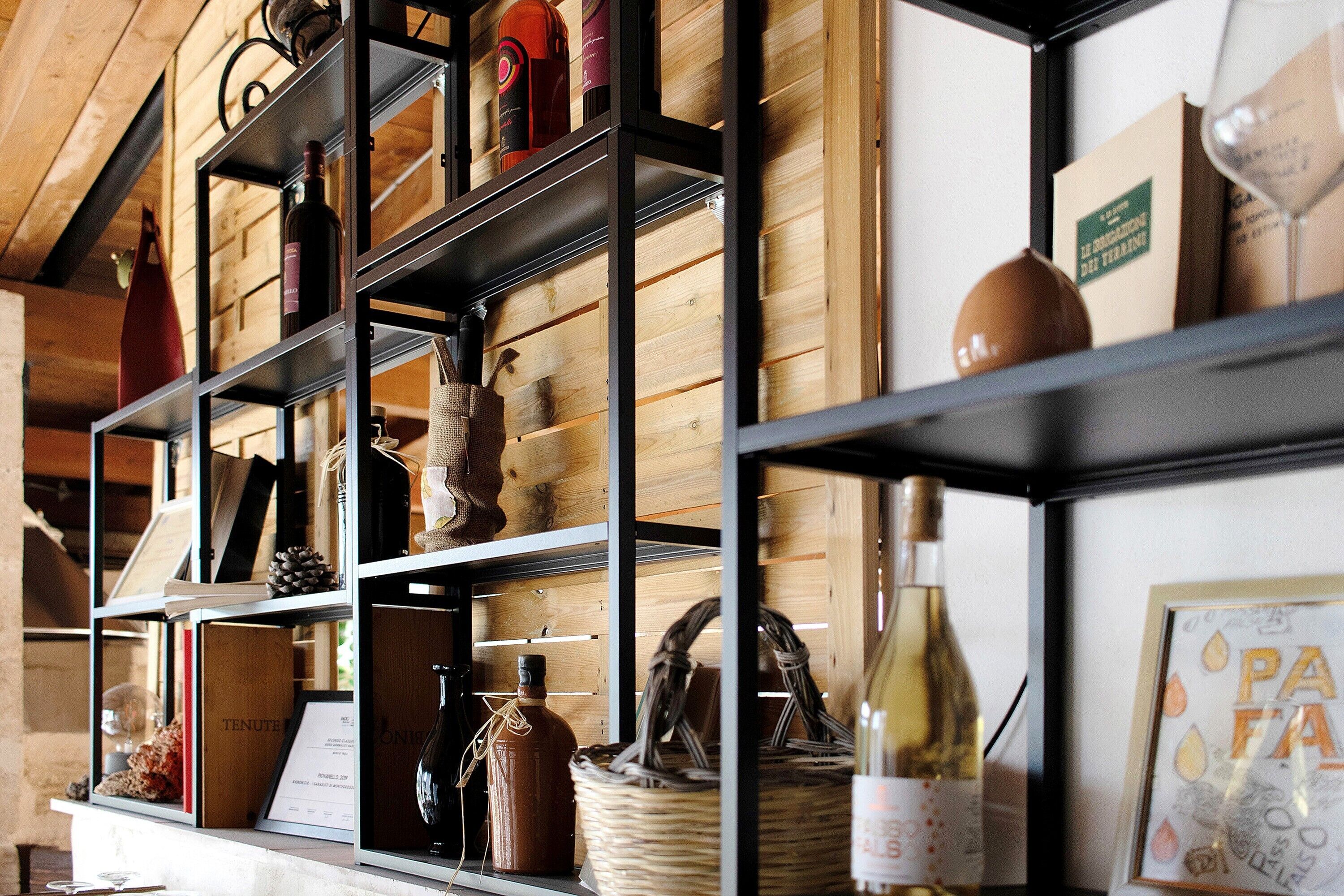 Un porte-bouteilles contenant des bouteilles de vin et un tableau encadré.