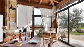 A dining area with a table set for two, a bottle of wine, and a candle on the table. - Terrace with Private Terrace, Wi-Fi and Air Conditioning (Montegrosso)