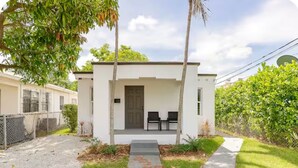 A modern two-story house with a front porch, a small garden, and a pathway leading to the entrance. - MIAMI-close to downtown/Wynwood/mid-town/Brickell (Miami)