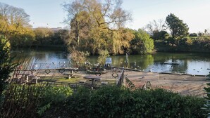 A riverside park with benches and a picnic area. - Drapers Cottage (Grange-over-Sands)