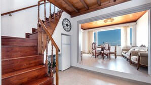 A wooden staircase leading to a dining area with a view. - Diamondbig House Country Home with Jacuzzi and Wi-Fi (Paros)