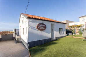 A building with a sign that reads 'Refúgio das Barcas' on the side. - Holiday Home 'Refúgio das Barcas' with Sea View, Wi-Fi & Air Conditioning (Lourinha)