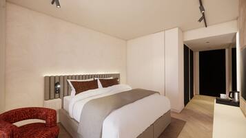 A modern bedroom with a large bed, a chair, and a desk with a lamp.