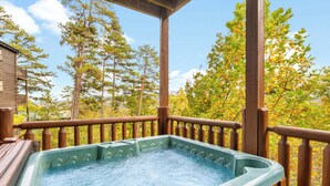 A hot tub on a wooden deck with a view of trees and mountains. - 4BR Cabin for 8 w/ Game Room & Hot Tub Haven! (Sevierville)