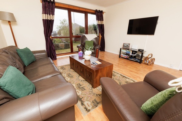 Living room with leather sofas and large windows