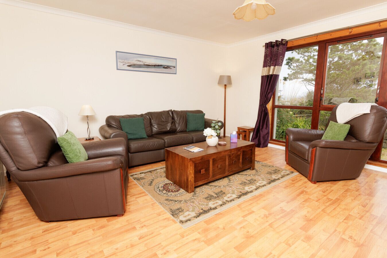 Living room with leather sofas and large windows