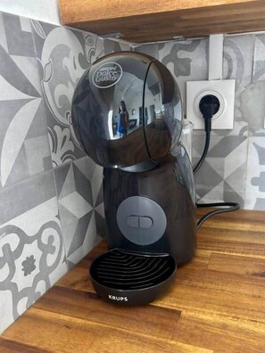 A Krups coffee maker on a wooden countertop with a patterned backsplash. - Gîte Mango-Passion Le Domaine Mannou (Sainte Rose)
