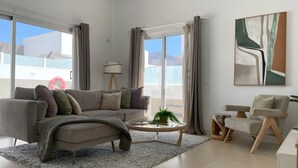 A modern living room with a sofa, coffee table, and a chair. - Vacation Home 'Lychee' with Private Pool, Wi-Fi and Air Conditioning (Las Palmas)