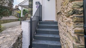 A stone building with a white door and a sign reading "The Studio." - The Studio (Windermere)