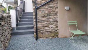 A stone building with a staircase leading to a door labeled "The Studio." - The Studio (Windermere)